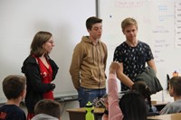 up close of three students answering questions in elementary classroom