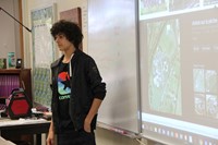 french exchange student shows elementary students where they go to school in france