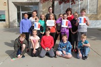 group of chenango bridge elementary student council members hold up signs to welcome french exchange