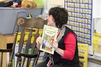 teacher holding up french book