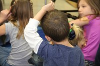 elementary student raising hand to ask a question