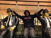 student with blues brothers statues