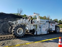 student getting hands-on experience with equipment at construction career day