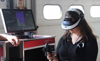 another student tests out virtual reality painting equipment at construction career day