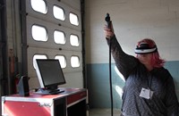 student tests out virtual reality painting equipment at construction career day