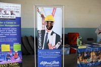 student smiles inside of construction career day college poster