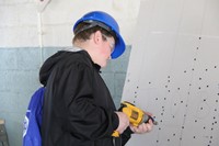 closer shot of student testing out drilling at construction career day