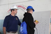 student tests out drilling at construction career day