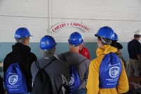 students talk to a man in the trade of carpentry