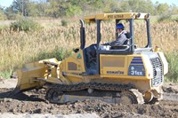 c v student equipment to move mud at construction career day