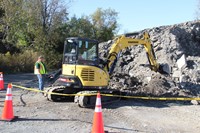 another angle of c v student lifting rocks with claw equipment at construction career day