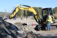 c v student uses machine with claw to pick up rocks