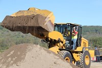 student dumping dirt using equipment at construction career day