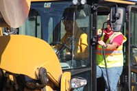 upclose of c v high school student working on controlling equipment to move dirt