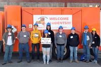 students in front of construction career day sign