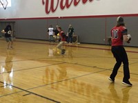 boys varsity football take place in passing challenge against a few teachers playing defense