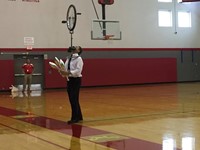 mister stafford juggling with a unicycle balancing on his face