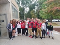 high school students doing warrior welcome stand in front of chenango bridge with principal hammond