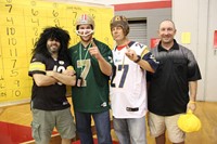 teachers dressed as football players and ref at pep rally