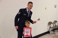 father in uniform and son smile for picture