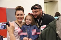 veteran parents smiling with daughter