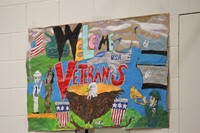 painted sign that says welcome veterans