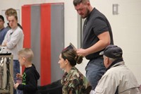 boy gives veteran a thank you card at port dickinson elementary