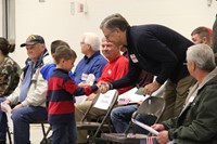 boy gives veteran handshake