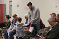 girl giving veteran thank you card