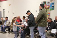 students giving veteran a thank you card