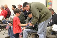 boy handing veteran thank you card