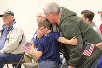 boy giving veteran a hug