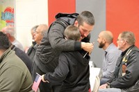 veteran gives family member hug after receiving thank you card