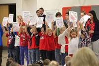 students holding up thank you cards