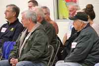 veterans listening to students read poems