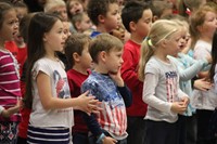 children signing and singing patriotic song