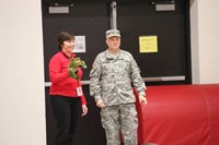 teacher and veteran standing near doorway