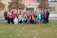 wide shot of student council and c v staff with flags in front of them