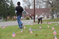 two students planting american flags