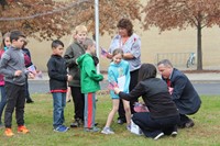 miss heller and mister gill handing out flags