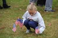 girl plants american flags