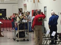 brass ensemble performing and veterans saluting