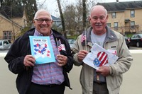 two veterans holding thank you cards