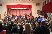 far shot of children singing at veterans day assembly