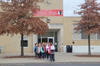 student council members walking out of school to plant flags