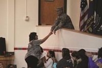 veteran from american legion giving principal hammond a recognition letter