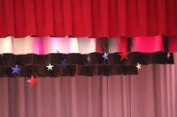 red white and blue stars hanging at top of stage