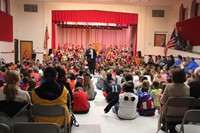 far shot of mister west talking to students