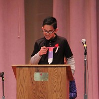 boy talking at podium at veterans day assembly