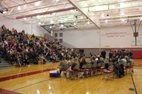 family members in stands watching students receive fall sports awards